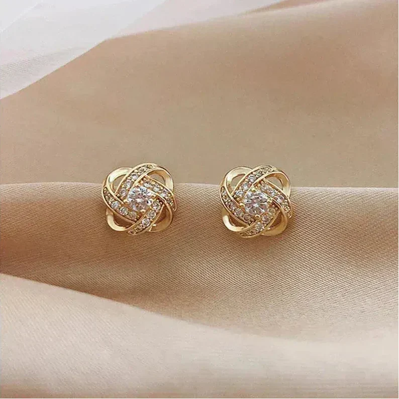 Lourdes - Boucles d’oreilles dorées en spirale avec cristaux étincelants
