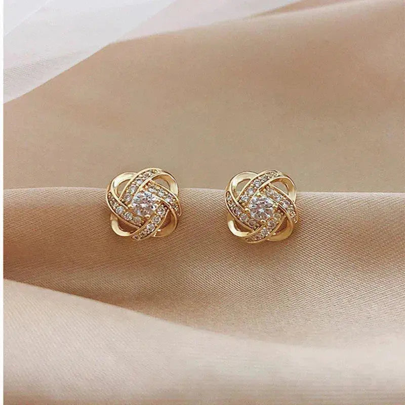 Lourdes - Boucles d’oreilles dorées en spirale avec cristaux étincelants