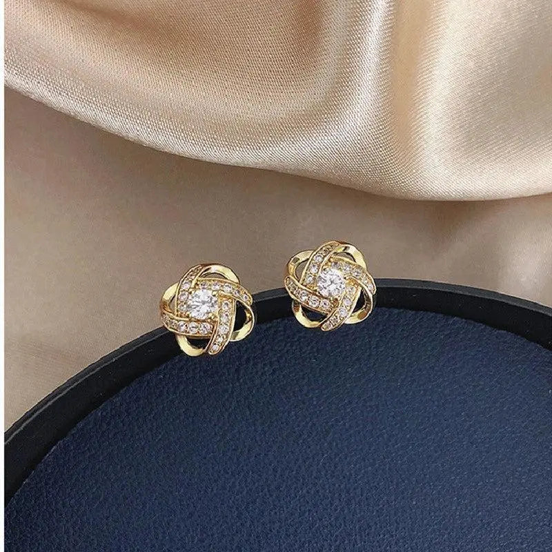 Lourdes - Boucles d’oreilles dorées en spirale avec cristaux étincelants